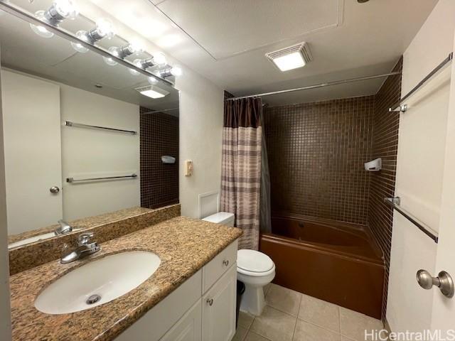 bathroom with tile patterned flooring, toilet, vanity, and shower / bathtub combination with curtain