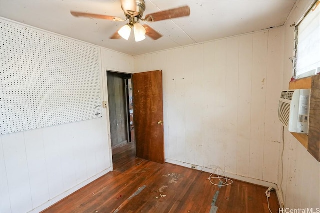 unfurnished room with a wall mounted air conditioner, a ceiling fan, and hardwood / wood-style floors