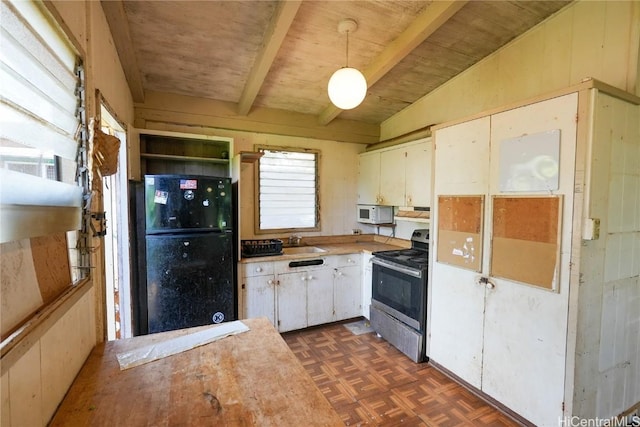 kitchen featuring stainless steel range with electric stovetop, decorative light fixtures, freestanding refrigerator, light countertops, and vaulted ceiling with beams