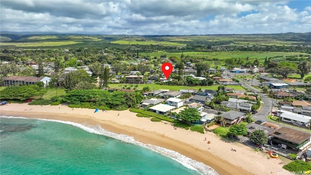 drone / aerial view featuring a water view and a beach view