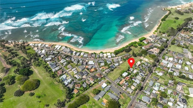 drone / aerial view featuring a beach view and a water view