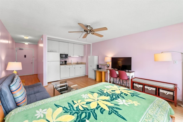 2345 Ala Wai Blvd Unit 1003, Honolulu, HI 96815 - bedroom with freestanding refrigerator, a sink, light wood-type flooring, and ceiling fan