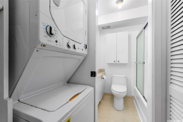 2345 Ala Wai Blvd Unit 1003, Honolulu, HI 96815 - full bathroom with stacked washer / drying machine, tile patterned floors, and enclosed tub / shower combo