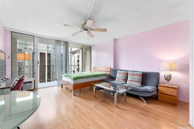 2345 Ala Wai Blvd Unit 1003, Honolulu, HI 96815 - living area featuring wood finished floors, a ceiling fan, a textured ceiling, and floor to ceiling windows