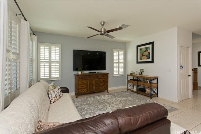 tiled living room featuring visible vents, baseboards, and ceiling fan