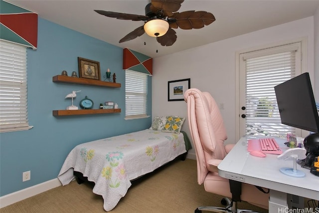 carpeted bedroom featuring baseboards and ceiling fan