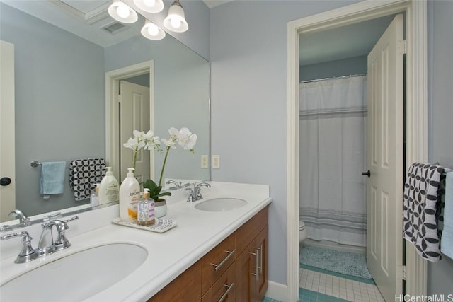 full bathroom featuring double vanity, visible vents, toilet, and a sink