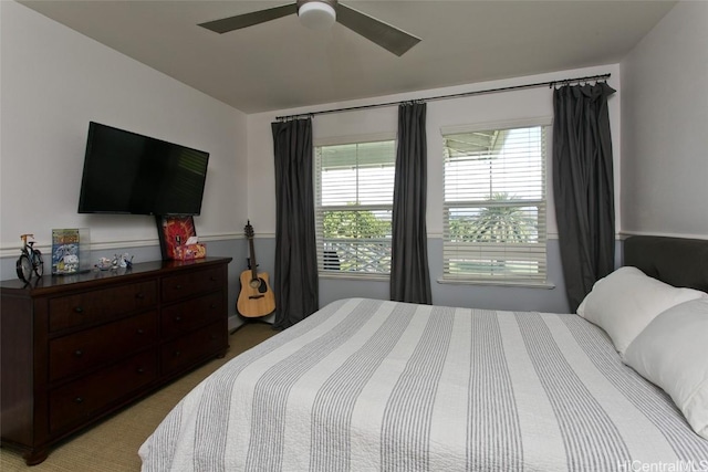 bedroom with a ceiling fan and light carpet