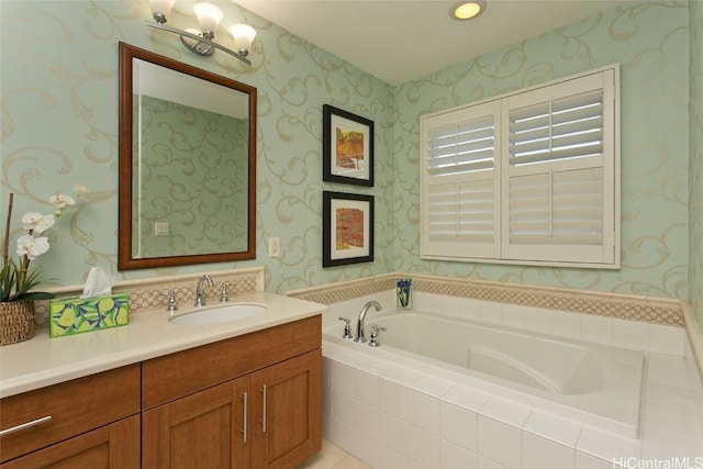 bathroom featuring wallpapered walls, a bath, and vanity