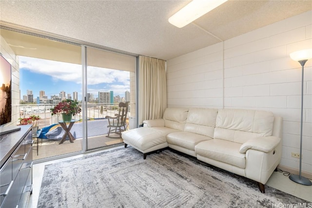 living area featuring expansive windows, a textured ceiling, and a city view