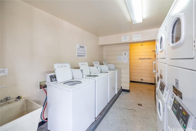 common laundry area with a sink, stacked washer and clothes dryer, and washing machine and clothes dryer