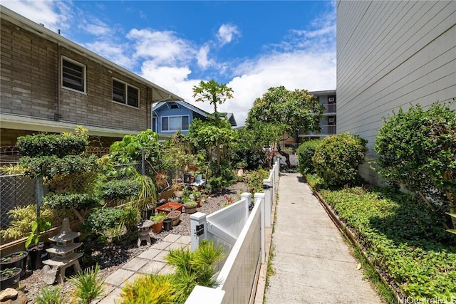 view of home's community featuring fence