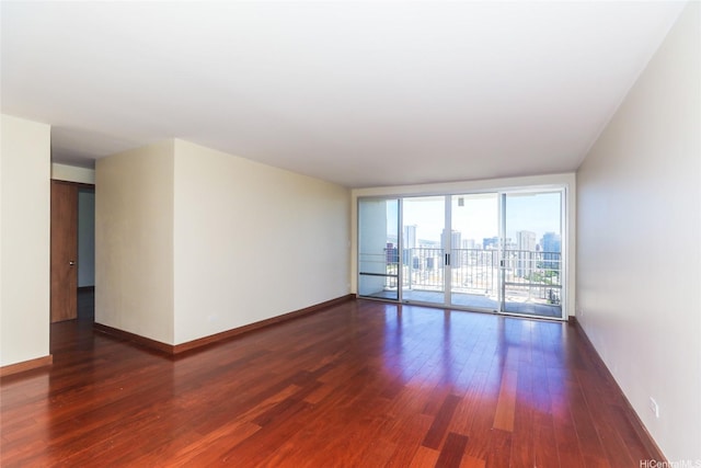 1350 Ala Moana Blvd Unit 3012, Honolulu, HI 96814 - spare room with wood finished floors, a wall of windows, baseboards, and a city view