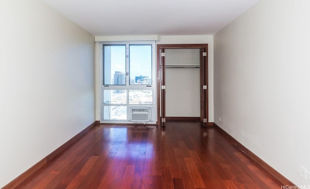 1350 Ala Moana Blvd Unit 3012, Honolulu, HI 96814 - unfurnished room featuring plenty of natural light, dark wood-style floors, a wall unit AC, and baseboards