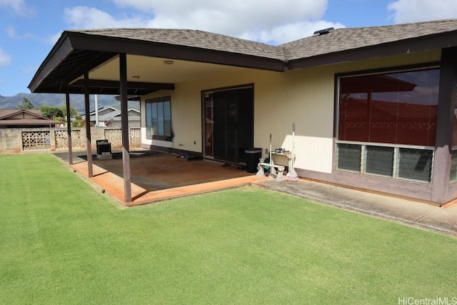 back of house featuring a yard, a patio, and fence