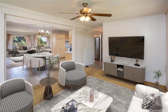 living room with light tile patterned floors and ceiling fan with notable chandelier