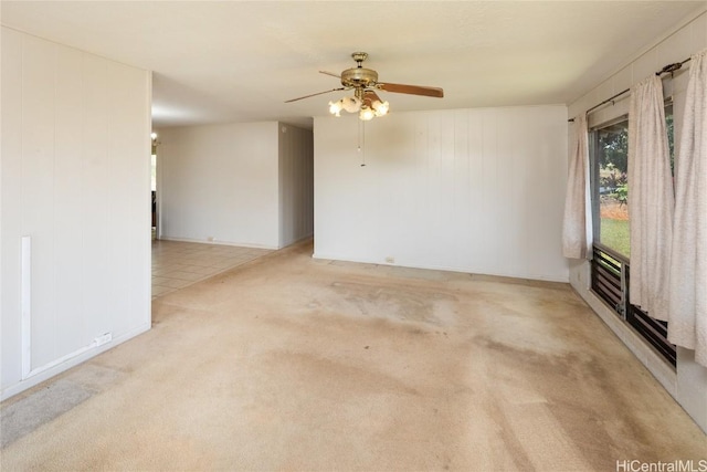 spare room featuring light colored carpet and ceiling fan