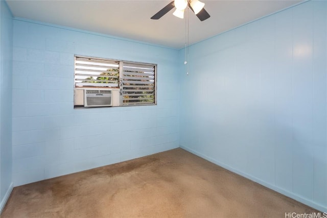 unfurnished room with concrete block wall, cooling unit, and a ceiling fan