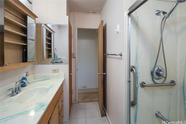 bathroom featuring vanity, tile patterned floors, and a shower with shower door