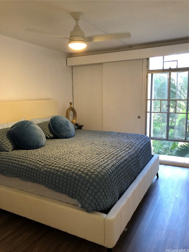 1519 Nuuanu Ave Unit 142, Honolulu, HI 96817 - bedroom with a ceiling fan and dark wood-style flooring