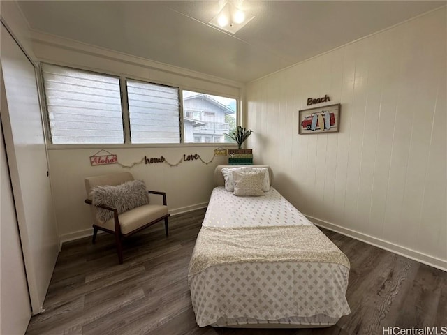 sitting room featuring baseboards and dark wood-style flooring