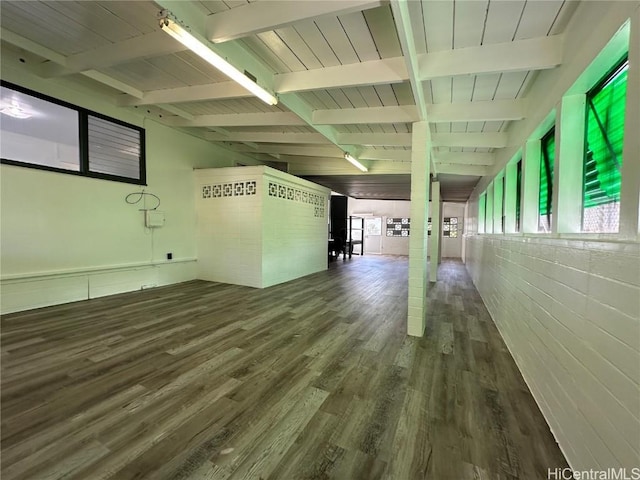 interior space featuring a wealth of natural light, wooden ceiling, wood finished floors, and vaulted ceiling with beams