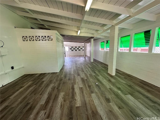 interior space featuring vaulted ceiling with beams and wood finished floors