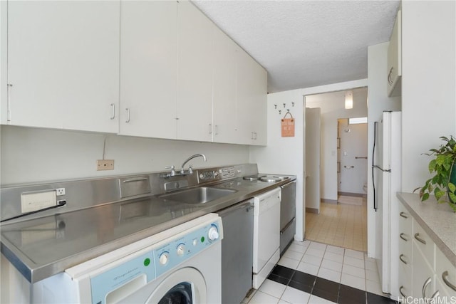 kitchen featuring white appliances, light tile patterned floors, a sink, white cabinets, and a textured ceiling