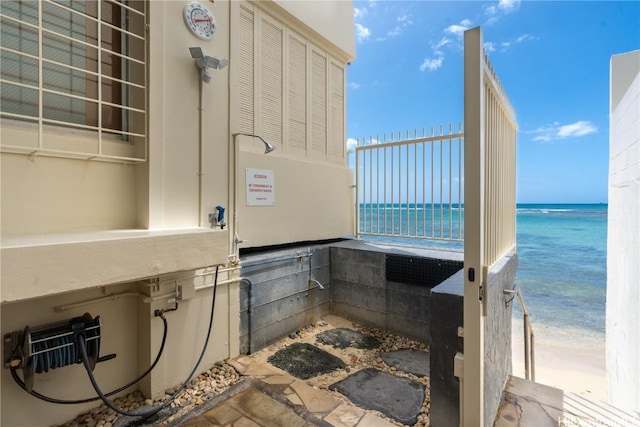 interior space featuring a beach view and a water view