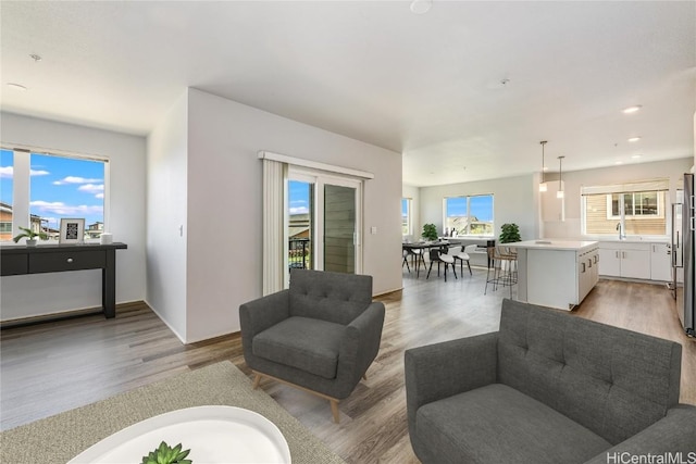 living room with recessed lighting and light wood finished floors