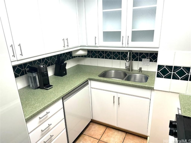 kitchen with a sink, backsplash, dishwasher, and white cabinets