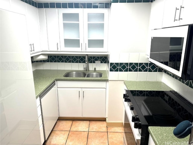 kitchen featuring electric range oven, a sink, white cabinets, dishwasher, and tasteful backsplash