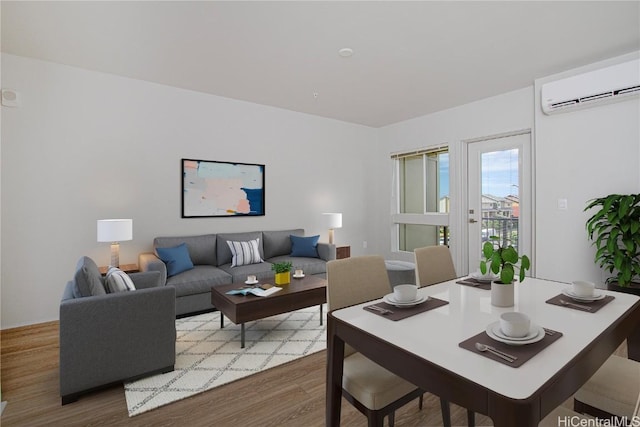 living area featuring a wall mounted air conditioner and wood finished floors