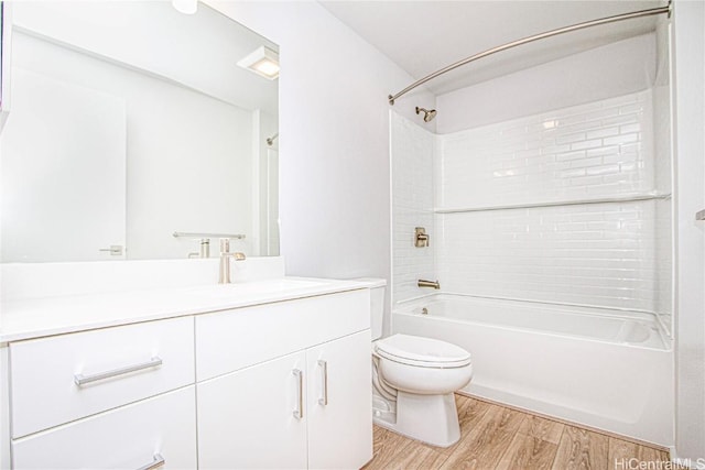 bathroom with toilet, shower / washtub combination, wood finished floors, and vanity