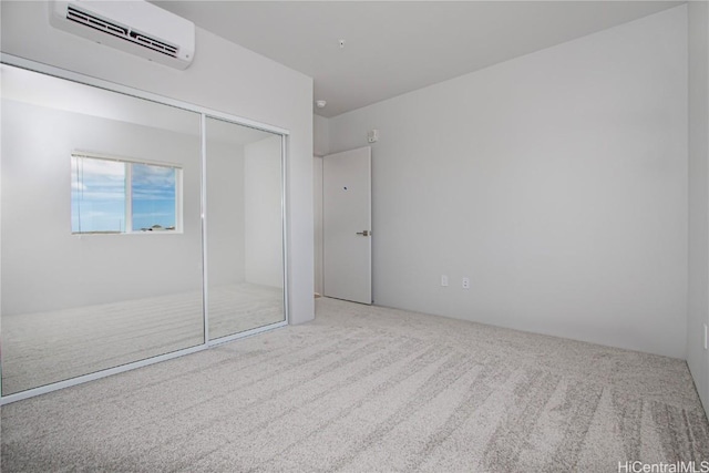 unfurnished bedroom with a closet, carpet floors, and a wall mounted AC