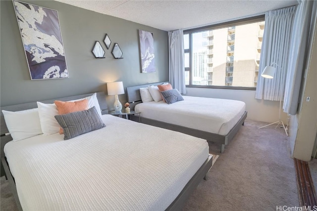 bedroom with carpet floors and a textured ceiling