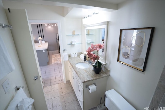 bathroom with vanity, toilet, and tile patterned flooring