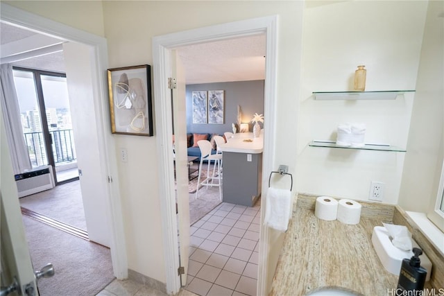 bathroom with tile patterned flooring and a wall unit AC