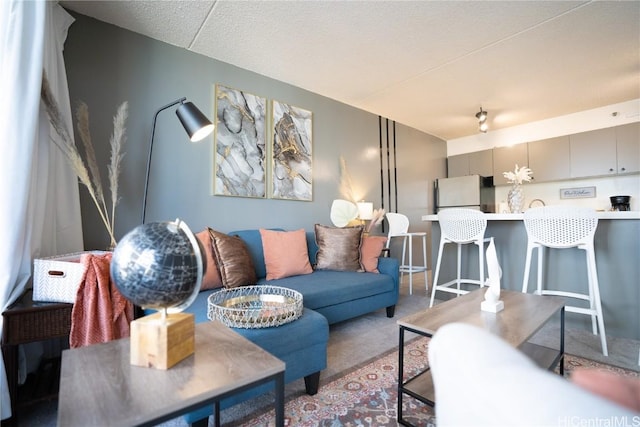 living area featuring carpet floors and a textured ceiling