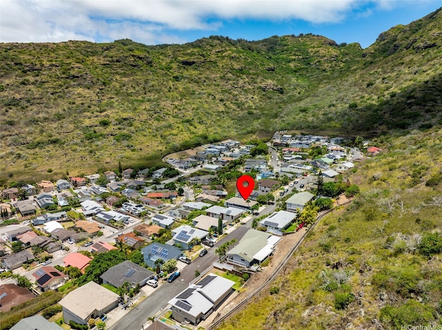 drone / aerial view featuring a wooded view, a residential view, and a mountain view