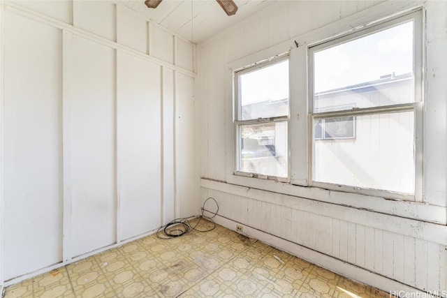 empty room featuring light floors and ceiling fan