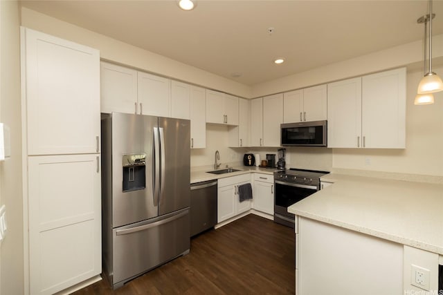 91-3575 Kauluakoko St Unit 1610, Ewa Beach, HI 96706 - kitchen with appliances with stainless steel finishes, light countertops, white cabinets, dark wood-type flooring, and recessed lighting