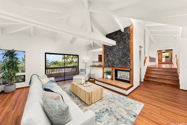 145 Maono Pl, Honolulu, HI 96821 - living area featuring stairway, a tiled fireplace, high vaulted ceiling, and wood finished floors