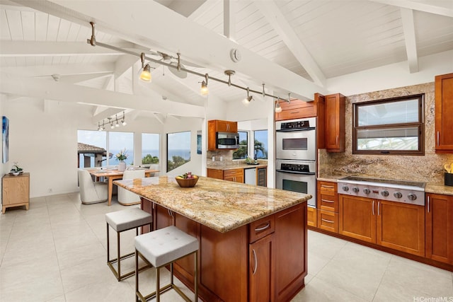 145 Maono Pl, Honolulu, HI 96821 - kitchen featuring decorative backsplash, brown cabinets, lofted ceiling with beams, appliances with stainless steel finishes, and a kitchen island