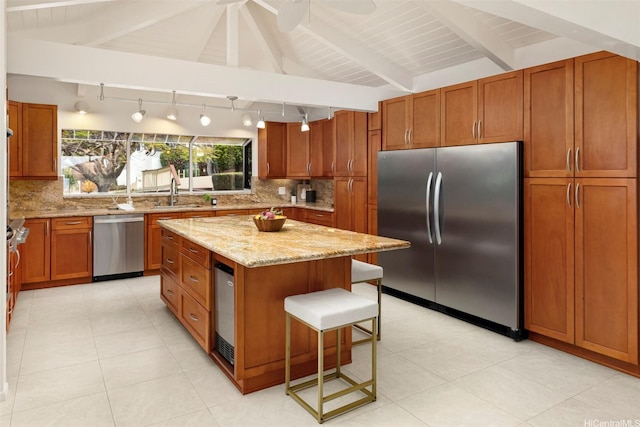 145 Maono Pl, Honolulu, HI 96821 - kitchen with brown cabinetry, a kitchen breakfast bar, decorative backsplash, and appliances with stainless steel finishes