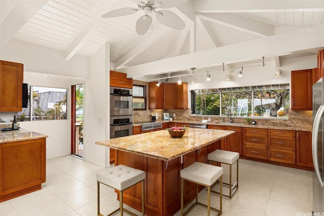 145 Maono Pl, Honolulu, HI 96821 - kitchen with track lighting, decorative backsplash, a kitchen breakfast bar, and a sink