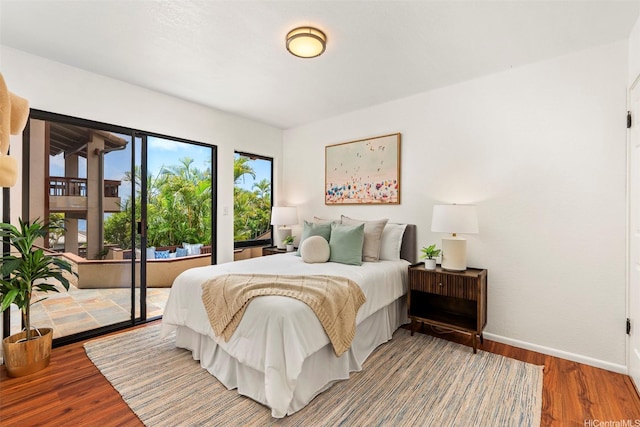 145 Maono Pl, Honolulu, HI 96821 - bedroom featuring baseboards, wood finished floors, and access to exterior