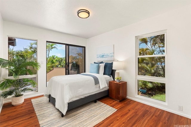 145 Maono Pl, Honolulu, HI 96821 - bedroom featuring baseboards, access to exterior, and wood finished floors