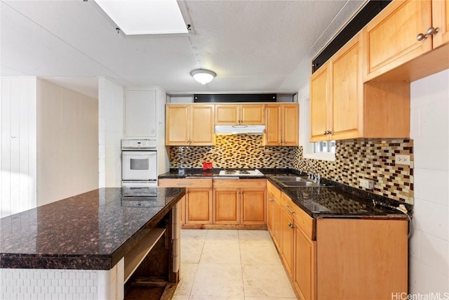 kitchen featuring tasteful backsplash, open shelves, under cabinet range hood, white appliances, and a sink