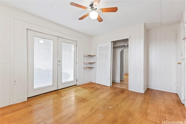 unfurnished bedroom with a ceiling fan, wood finished floors, french doors, and a closet